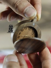 تصویر ساعت جیبی چوبی از چوب گردو برند چوبشور در سایز مینی با آویز زنجیر طلایی 