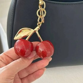 تصویر ست کیف زنانه و مردانه طرح آلبالو 