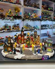 تصویر دهکده برفی موزیکال کریسمس،بابانوئل روی نردبان 