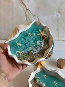 تصویر شمع دریایی با ظرف صدف 