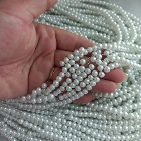 تصویر مروارید سنگی رنگ سفید ،سایز 6،بصورت ریسه 144 عددی 