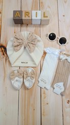 تصویر توربان شیری رنگ‌ با تزین خامه دوزی 