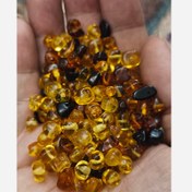 تصویر مهره سنگ کهربای نامنظم سوراخ دار سنگ اصل درجه یک طبیعی معدنی راف تراش نخورده دفرمه 