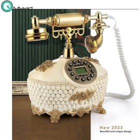 تصویر تلفن سلطنتی رومیزی رایکا مدل 340، تلفن سلطنتی با طراحی طرح نقش برجسته روی بدنه تلفن، شماره گیر دکمه ای و دارای کالر آیدی، دکوری شیک و جذاب مناسب منزل و محل کار| رنگ سفید طلایی 
