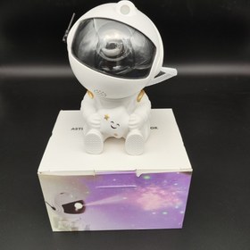 تصویر چراغ خواب پروژکتور کهکشانی مدل فضانورد نشسته ا Starry Sky Projector LED Astronaut Light Laser 