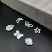 تصویر مهره کرومی پروانه و صدف و ستاره و ماه و پاپیون 