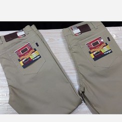 تصویر شلوار کتان مردانه کشی رنگ کرم روشن تا خاکی 