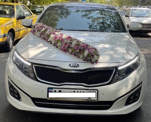 تصویر ماشین عروس کیا اوپتیما سفید با دسته گل عروس | کد: ZNB-PJO 