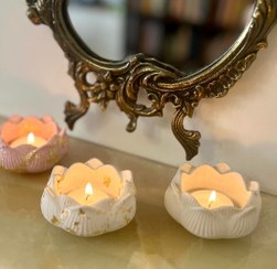 تصویر جا شمعی سنگ مصنوعی و شمع مدل گل نیلوفر 