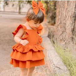 تصویر پیراهن چین دار لنین فشن دخترانه بچگانه رنگ کرم و نارنجی مناسب یک تا هفت سال 