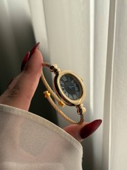 تصویر ساعت بنگلی بیضی طلایی ص مشکی 