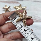 تصویر دکمه دفرمه ستاره دریایی بزرگ طلایی(سه سایز) 