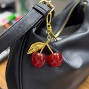 تصویر ست کیف زنانه و مردانه طرح آلبالو 