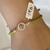 تصویر دستبند نخی طلا مدل ثور نماد ماه اردیبهشت با بند سبز صدری - طلای ۱۸ عیار 
