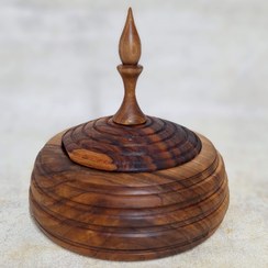 تصویر آجیل خوری در دار چوبی تهیه شده از چوب گردو 