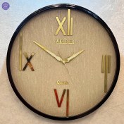 تصویر ساعت دیواری مشکی‑طلایی ولدر با اعداد رومی 