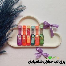 تصویر لیپ گلاس (شاین لب) گلیتری طرح بطری شامپاین برند هدا بر Huda Bear Lipgloss Huda Bear Lipgloss