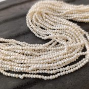 تصویر مروارید پرورشی سایز ۲ میلیمتر رنگ سفید طول ریسه ۳۶ سانتیمتر 