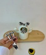 تصویر چنگال زیتون خوری سفید نقره‌ای 