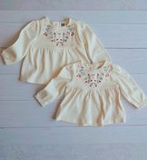 تصویر سارافون نوزادی گلدوزی شده برند C&A 