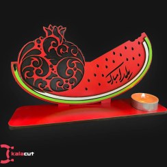 تصویر استند یلدایی طرح انار و هندوانه به همراه شمع 