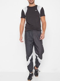 تصویر شلوار بافتی معمولی CB با دم‌پای کشی در رنگ مشکی برند asics Regular Fit CB Woven Cuffed Pants Performance Black